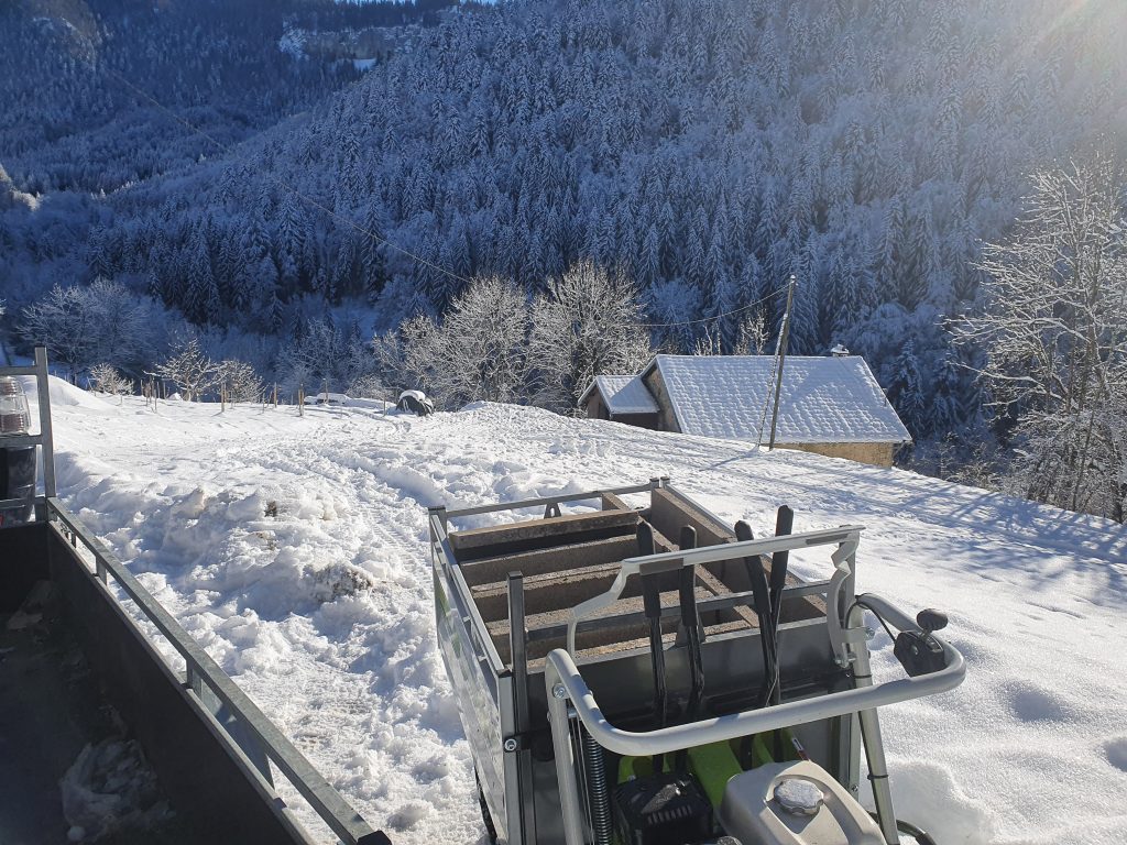 Utilisation de la brouette à chenille dans la neige pour descendre des parpaings qui seront utilisés pour créer l'assainissement Aquatiris